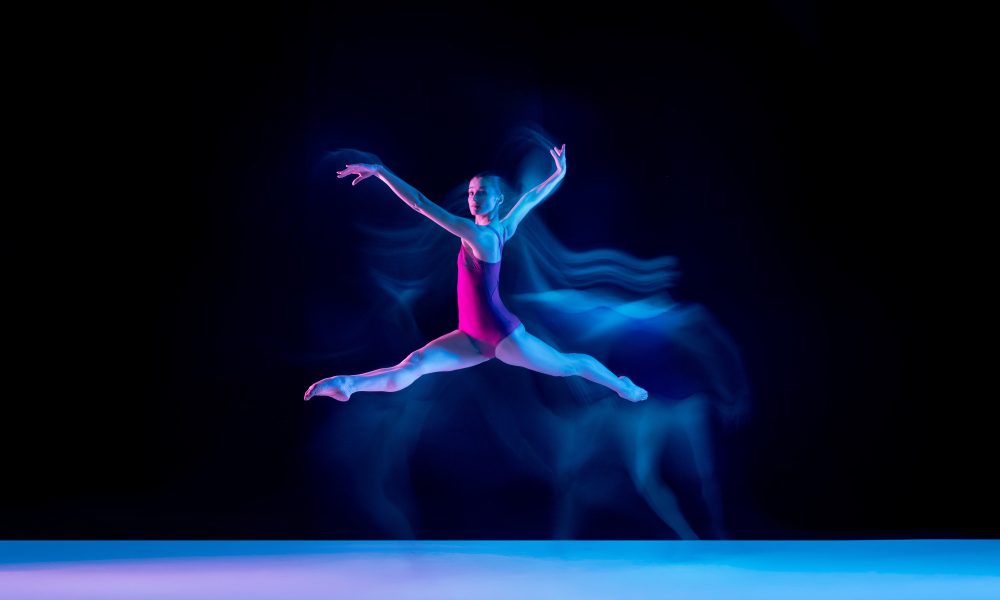 young-graceful-ballet-dancer-isolated-purple-studio-background-neon-light